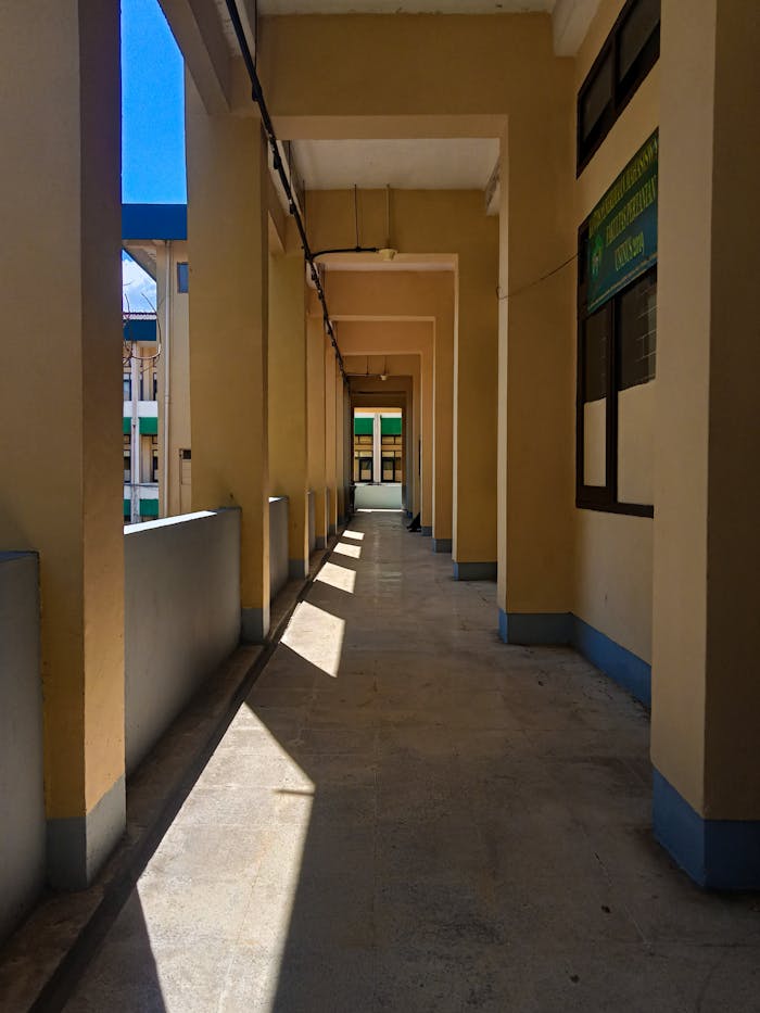 A bright hallway in Bandung, Indonesia with sunlight casting shadows.