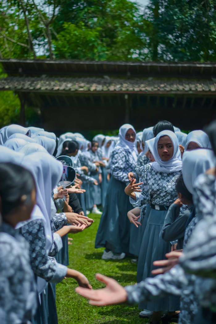 A group of students in uniforms participating in an outdoor team building activity.