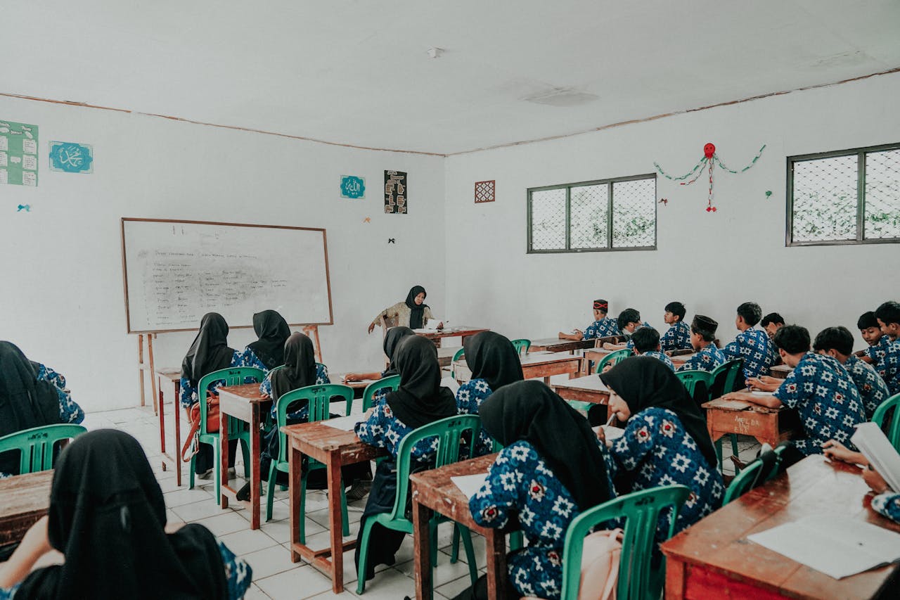 Students in traditional attire attend a lesson in a Pandeglang classroom.
